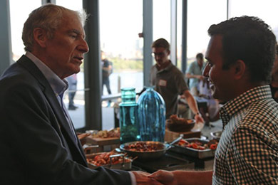 Stephen Kaufman shaking hands with a student